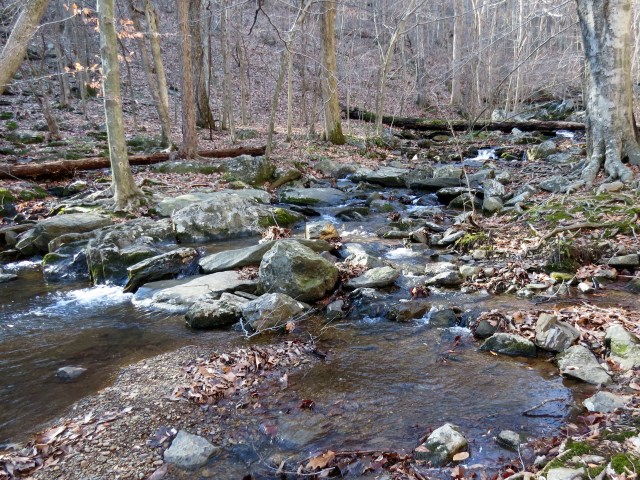 The water is wearing the granite away. VERY slowly. 