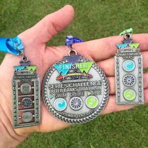 Left is Olympic medal, right is Sprint medal, center is medal for completing two in two days