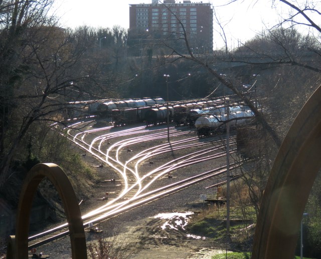 Railroad tracks gleam in the evening sun at the south end of the Tyler Potterfield Bridge 